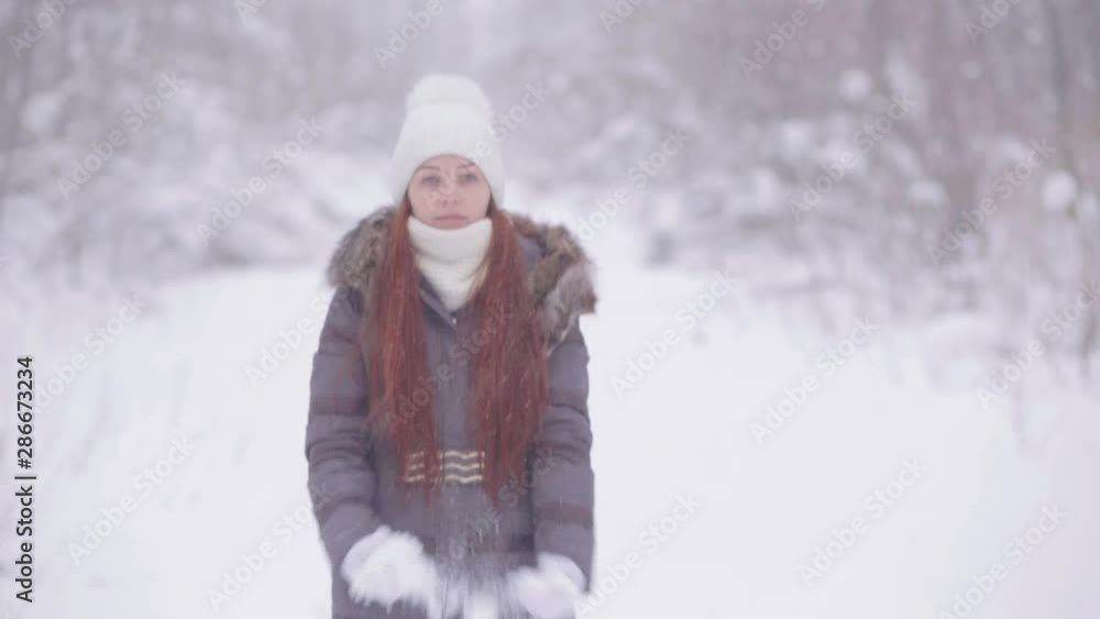 portrait of a young woman near the Christmas tree in the winter evening on the square. portrait of a young woman near the Christmas tree in the winter evening on the square.