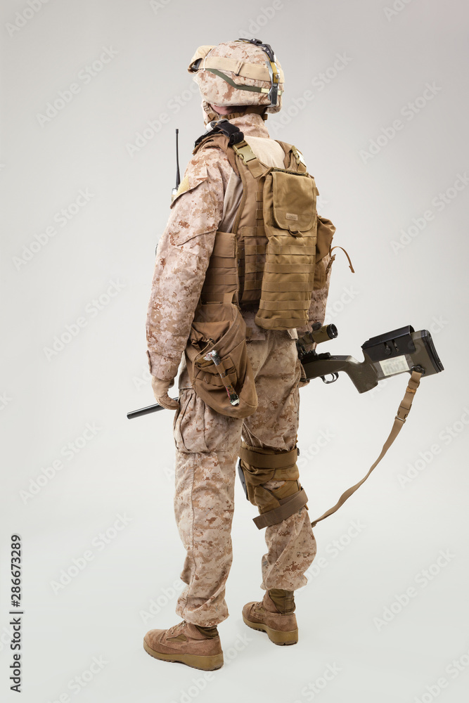 Studio shoot of modern infantry soldier, U.S. marine rifleman in combat uniform, helmet and body armor Studio shoot of modern infantry soldier, U.S. marine rifleman in combat uniform, helmet and body armor