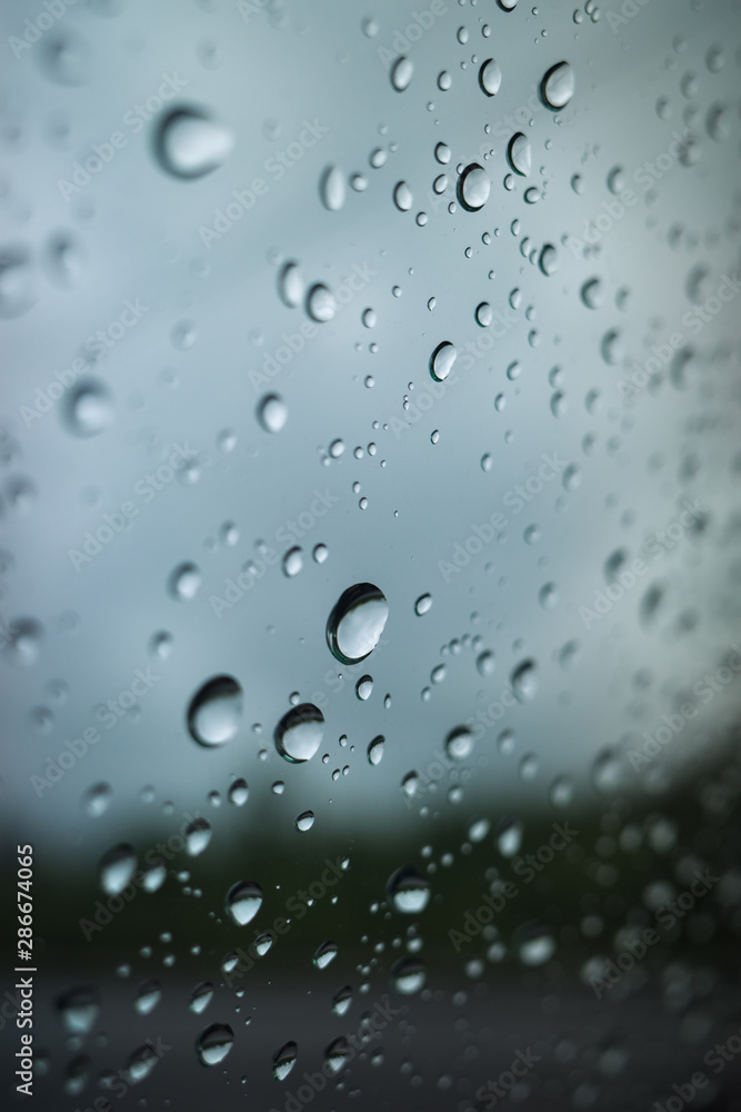 raindrops on the glass, on a gray background. Selective focus raindrops on the glass, on a gray background. Selective focus