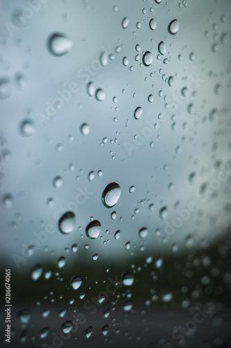 raindrops on the glass, on a gray background. Selective focus