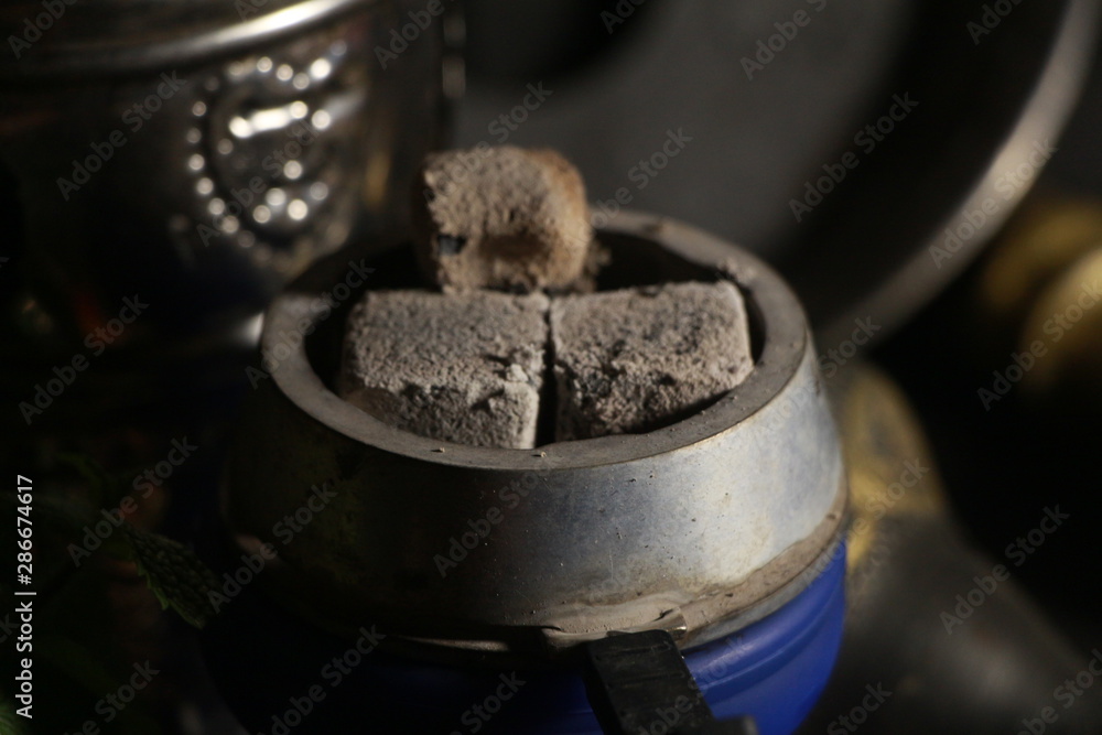 bowl with tobacco for hookah. fruits on a black background bowl with tobacco for hookah. fruits on a black background