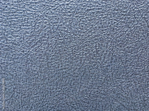 Texture of blue wallpaper with a pattern. Silver paper surface, structure closeup.