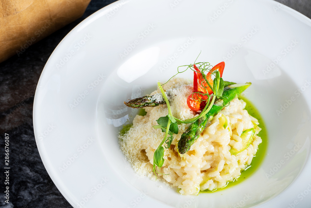 Close up view on tradtional and tasty risotto with parmesan, asparagus and chili. Mediterranean and italian cuisine. Soft, selective focus. Rise with asparagus. Copy space. Food photography Close up view on tradtional and tasty risotto with parmesan, asparagus and chili. Mediterranean and italian cuisine. Soft, selective focus. Rise with asparagus. Copy space. Food photography