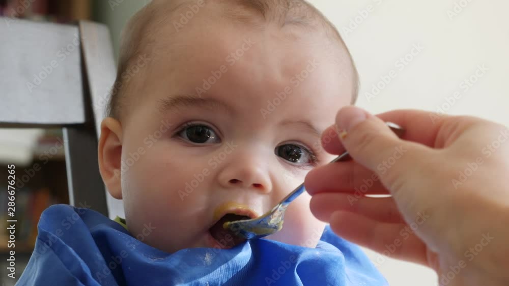 Baby girl being fed food for lunch Baby girl being fed food for lunch