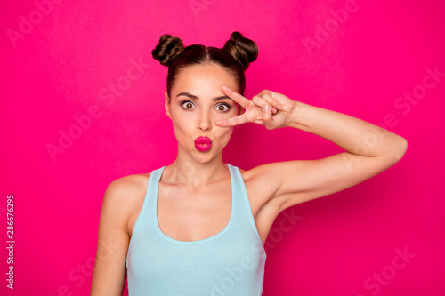 Fotografiet Close up photo of pretty teen making v-signs faces wearing blue singlet isolated