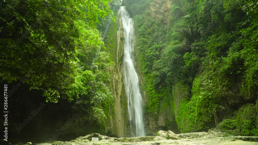 Mantayupan Falls in the jungle, island of Cebu, Philippines. Waterfall in the green forest. Mantayupan Falls in the jungle, island of Cebu, Philippines. Waterfall in the green forest.