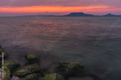 Sunset at Balaton Lake with sleeping vulcanos in the background