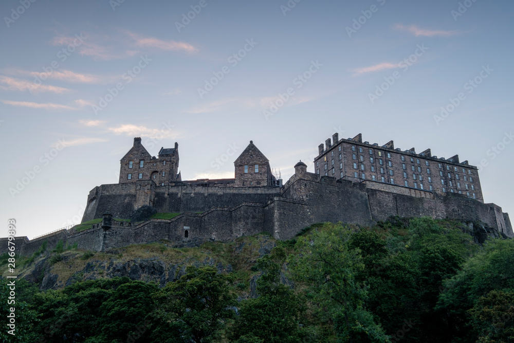 Edinburgh castle at sunrise with small pink clouds, Edinburgh, Scotland, uk