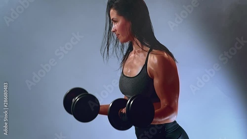 Fitness sweaty woman with heavy weights. Sport and healthy lifestyle concept
