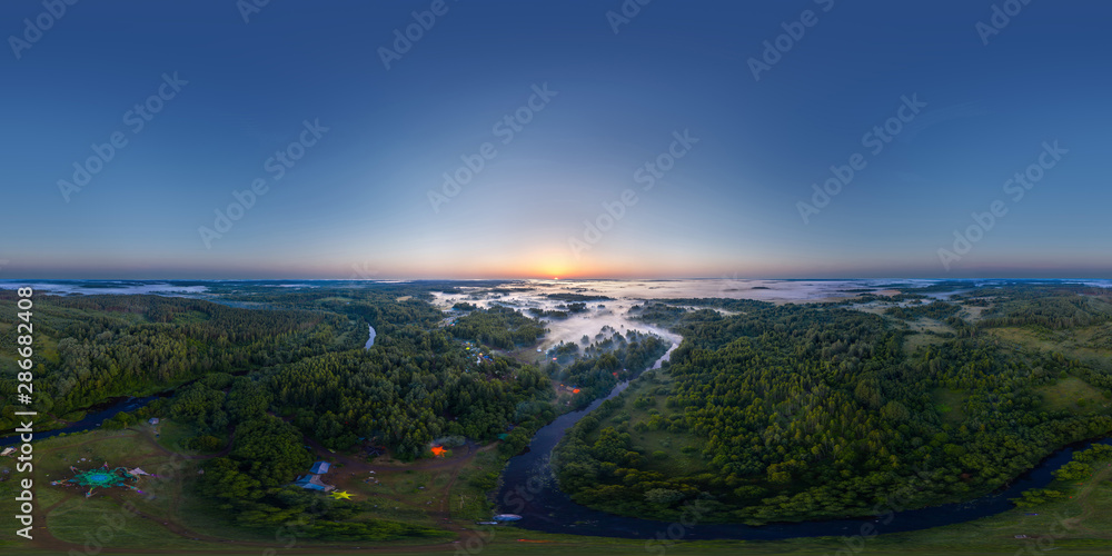 360-degree panoramic aerial view of the field, forest and river covered with a thick layer of morning fog