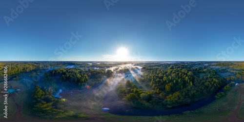 360-degree panoramic aerial view of the field, forest and river covered with a thick layer of morning fog