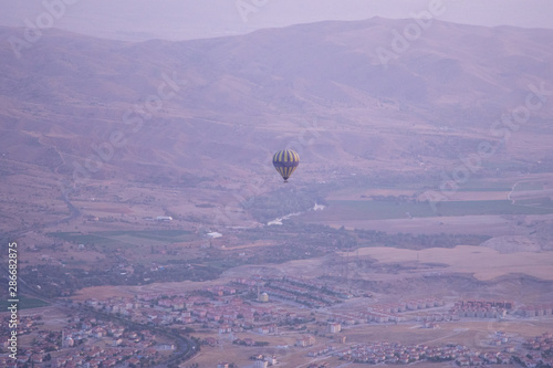 Hot air balloons over mountain landscape in Cappadocia Basket, levitation on October