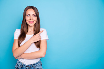 Portrait of cute person looking showing ads on copy space wearing white t-shirt denim isolated over blue background