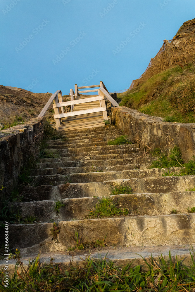 wooden and stone stairs on Barrika beach in Biscay