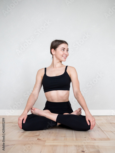 Fototapeta Naklejka Na Ścianę i Meble -  Attractive flexible girl doing yoga exercises