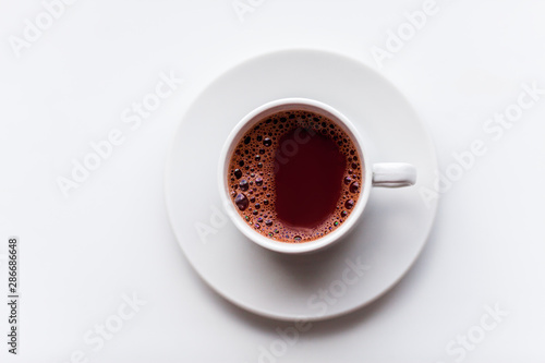 White hot coffe cup on windowsill