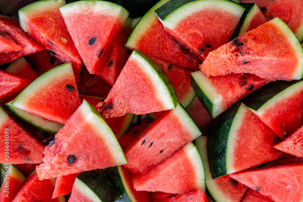 Red watermelon,heap of watermelon slices as background Red watermelon,heap of watermelon slices as background