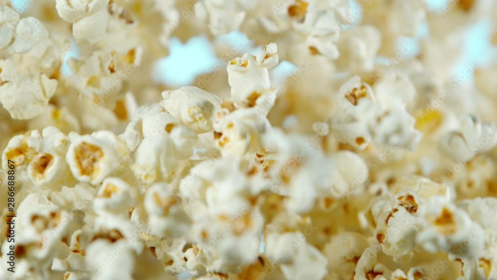 Super slow motion of falling popcorn on coloured background. Filmed on high speed cinema camera, 1000fps. Super slow motion of falling popcorn on coloured background. Filmed on high speed cinema camera, 1000fps.