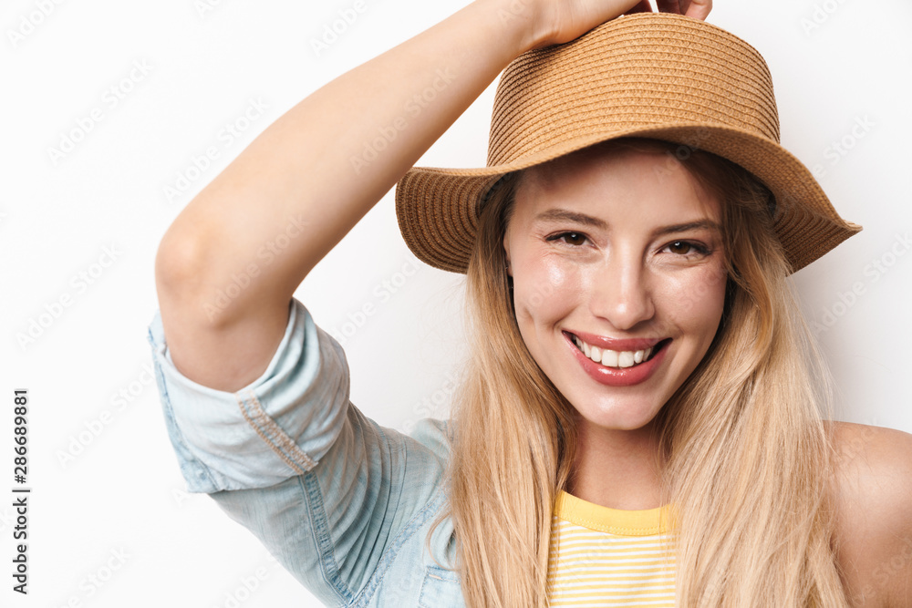 Happy smiling optimistic young pretty woman wearing hat posing isolated over white wall background. Happy smiling optimistic young pretty woman wearing hat posing isolated over white wall background.