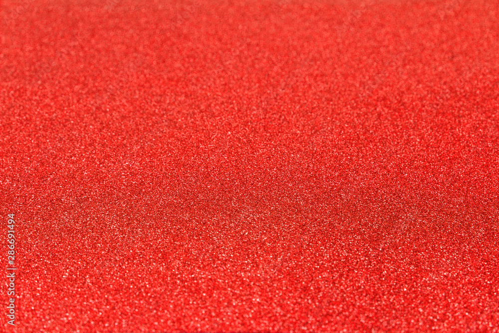 Shiny glitter red bachground texture. Glittering red paper
