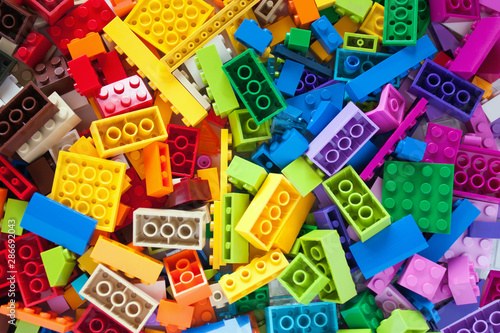 Lot of colorful rainbow toy bricks background. Educational toy for children.