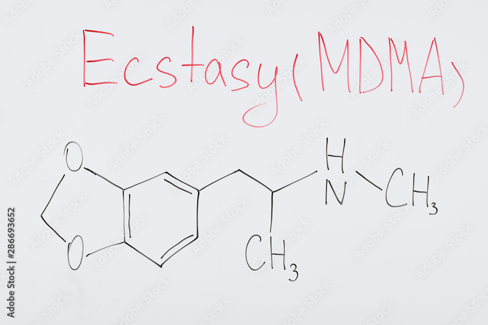 top view of white board with chemical formula and lettering ecstasy