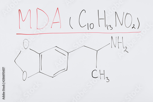 top view of white board with chemical formula and lettering mda photo