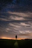 Silhouette of a man at night, under the stars in Sagres, Portugal