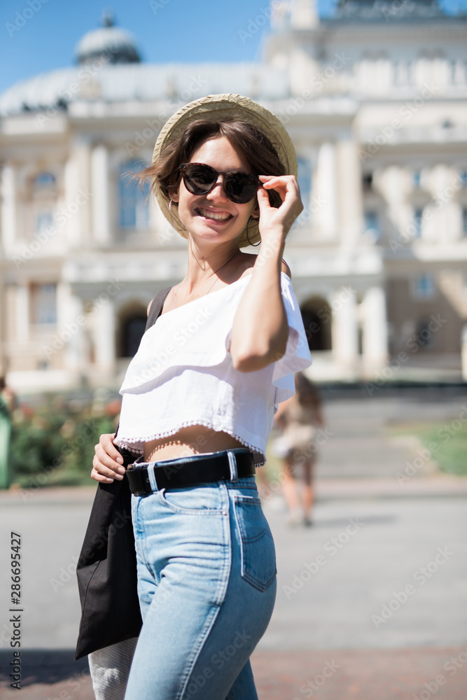 Beautiful brunette young woman walking on the street Beautiful brunette young woman walking on the street