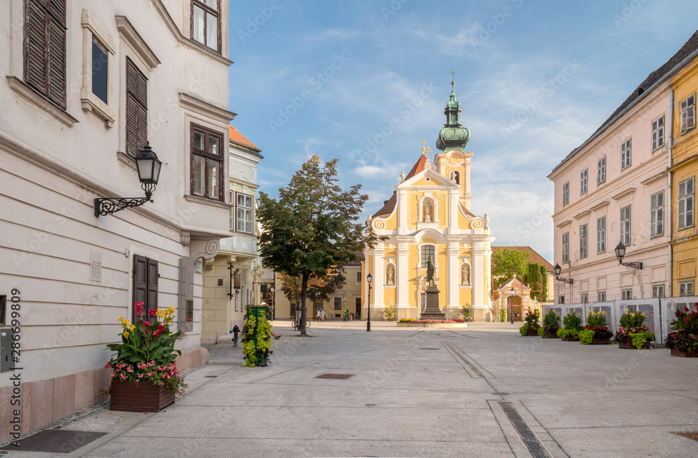 The Baroque Carmelite Church at Vienna Gate Square in Gyor, Hungary during sunset