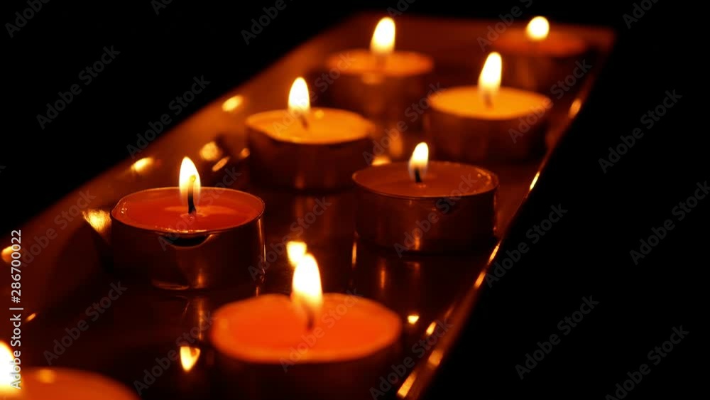 beautiful fire of a candle in a dark room a warm yellow light candle , fire of a candle burning in the dark beautiful fire of a candle in a dark room a warm yellow light candle , fire of a candle burning in the dark
