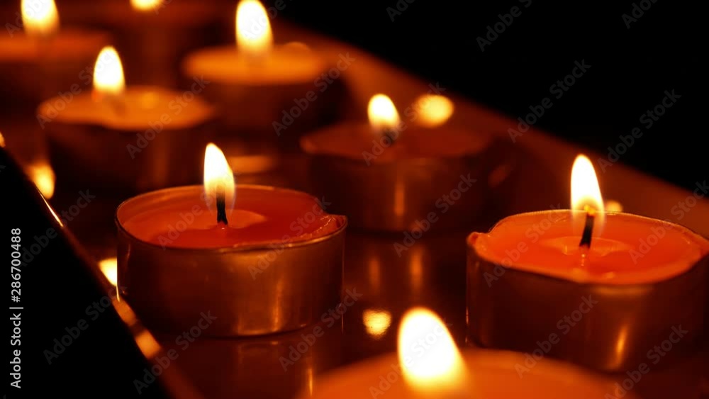 beautiful fire of a candle in a dark room a warm yellow light candle , fire of a candle burning in the dark beautiful fire of a candle in a dark room a warm yellow light candle , fire of a candle burning in the dark