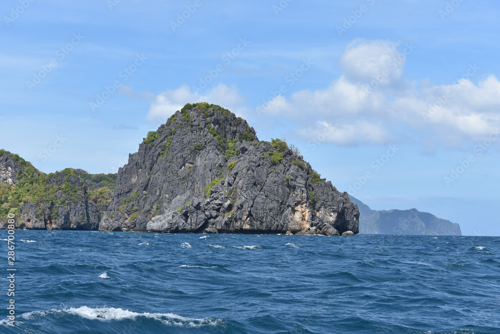 Small rock formations and blue waters