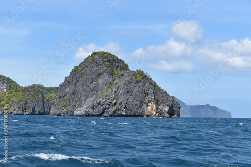 Small rock formations and blue waters
