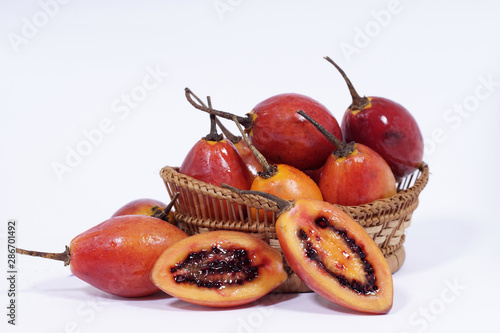fresh tamarillo fruit on bamboo basket isolated on white