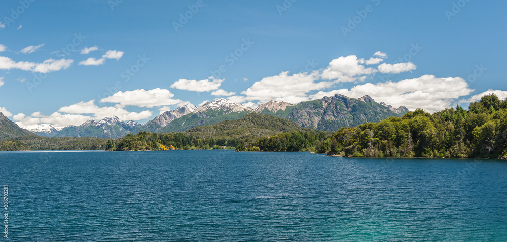 Nahuel Huapi lake, San Carlos de Bariloche (Argentina). Waves on the lake. Mountains with fresh snow surrounding the lake.