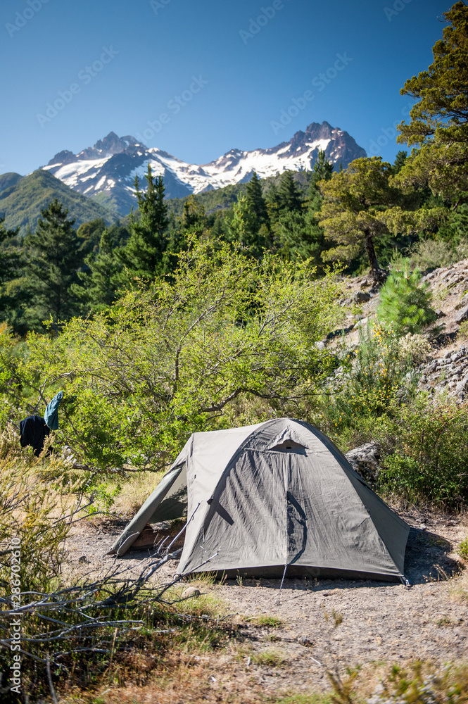 Camping green tent in Antuco volcano black volcano desert. Camping in mountains. Outdoor vacation.