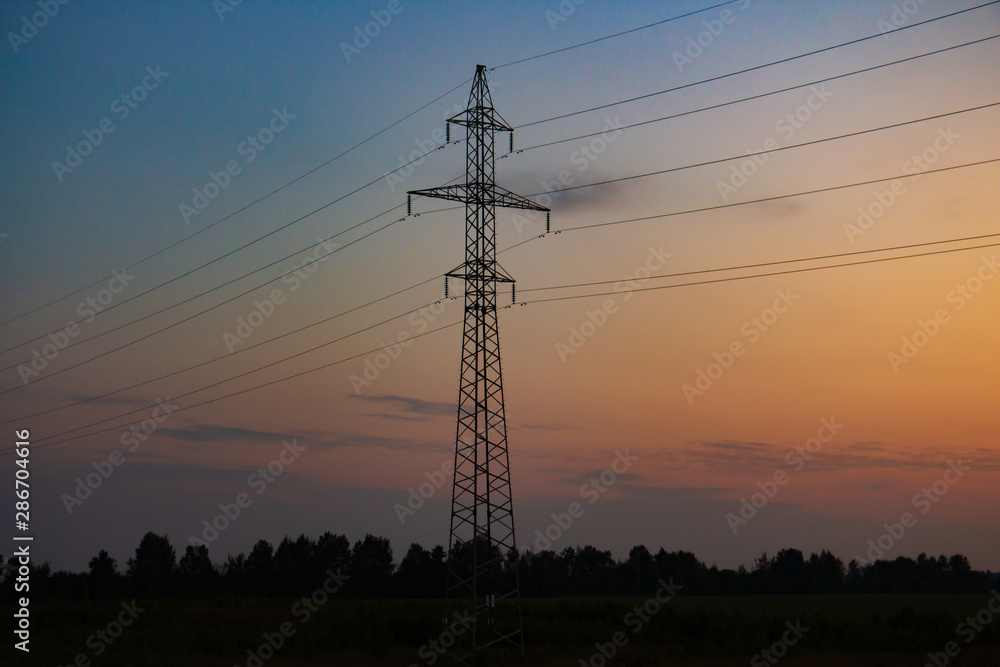 electric poles on the background of sunrise