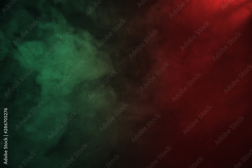 Red and green smoke on the dark background