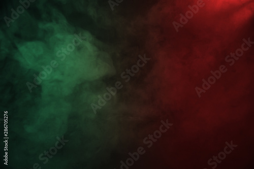 Red and green smoke on the dark background