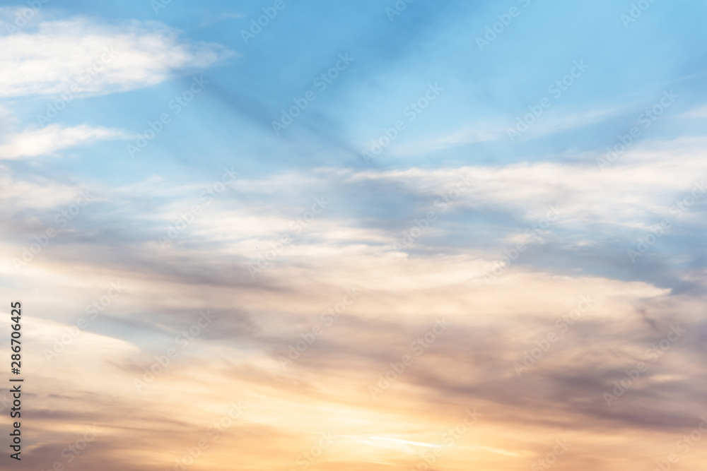 sunset background. sky with soft and blur pastel colored clouds. sunshine through the gradient cloud on the beach resort. nature. sunrise.  peaceful morning