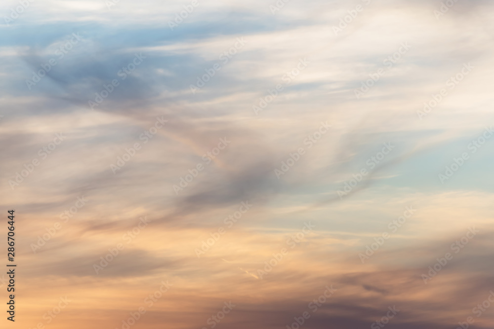 sunset background. sky with soft and blur pastel colored clouds. sunshine through the gradient cloud on the beach resort. nature. sunrise.  peaceful morning