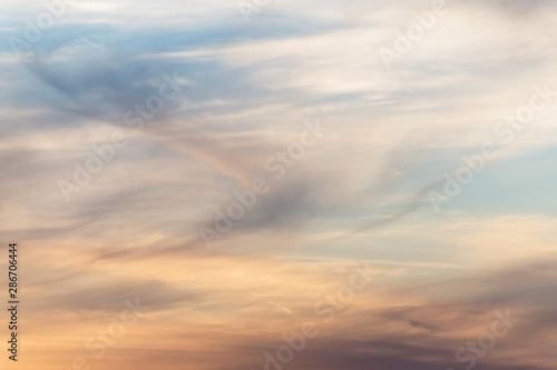 Fototapeta Naklejka Na Ścianę i Meble -  sunset background. sky with soft and blur pastel colored clouds. sunshine through the gradient cloud on the beach resort. nature. sunrise.  peaceful morning