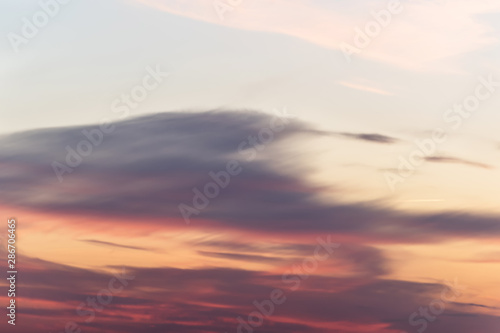 sunset background. sky with soft and blur pastel colored clouds. sunshine through the gradient cloud on the beach resort. nature. sunrise.  peaceful morning © flowertiare
