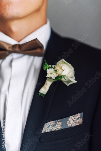 Close-up of a groom's buttonhole on a jacket