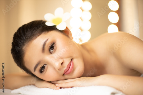 Asian Beautiful, young and healthy woman in spa salon. Massage treatment spa room  . Traditional medicine and healing concept.