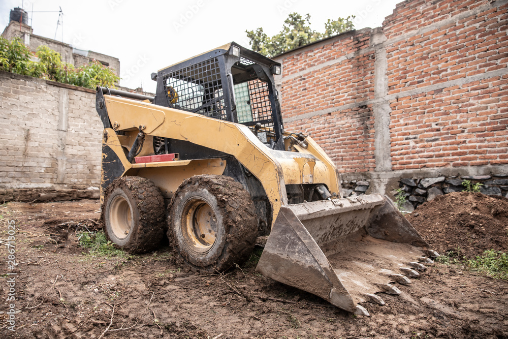Excavator machine working on during a construction. Excavator machine working on during a construction.