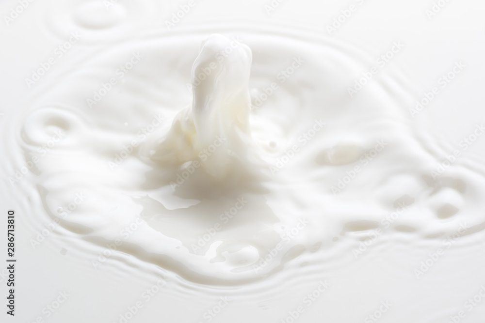splash on the surface of white milk on a white background splash on the surface of white milk on a white background