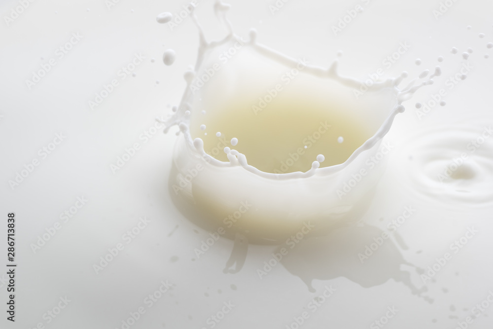 splash on the surface of white milk on a white background splash on the surface of white milk on a white background