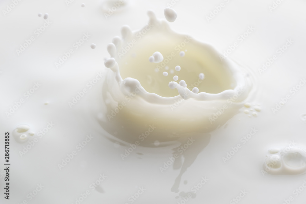 splash on the surface of white milk on a white background splash on the surface of white milk on a white background
